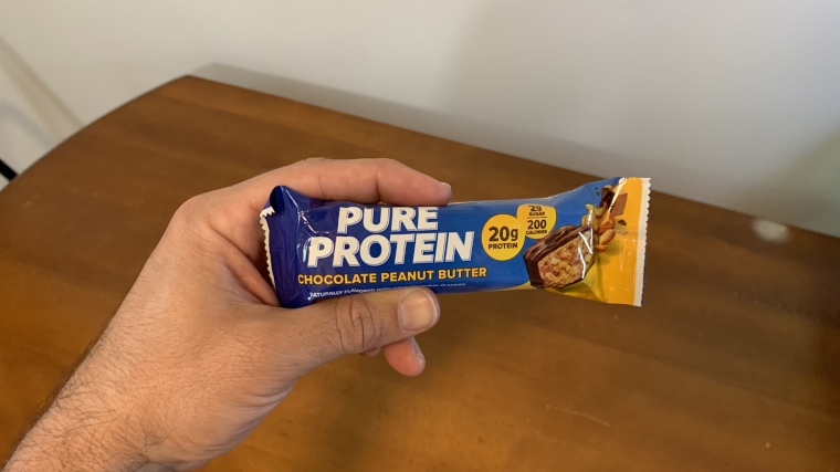 Our tester holding a wrapped Pure Protein Protein Bar