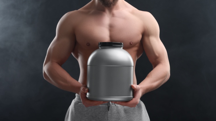 Man holding blank whey protein tub to build muscle