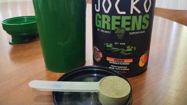 A scoop of Jocko Greens with the container