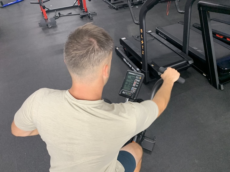 a person using the Assault Fitness AirBike Elite.