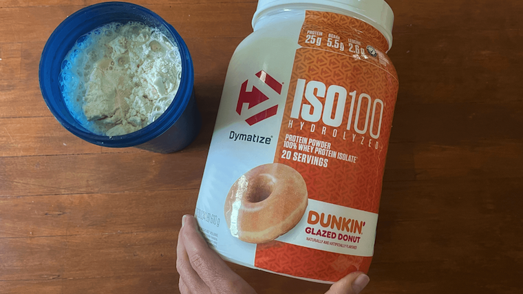 A person making a shake of Dymatize Iso 100 protein powder