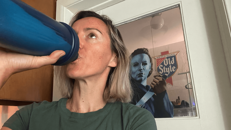 A person enjoying a shake of Dymatize Iso 100 protein powder