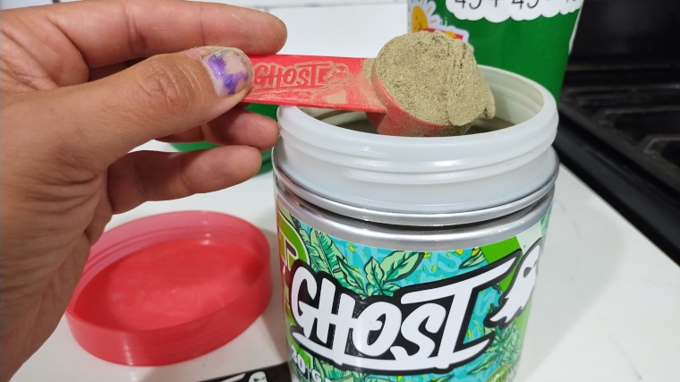 Our tester scoops up some Ghost Greens powder.