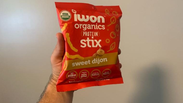 Our tester holding a bag of IWON Organics Protein Stix.