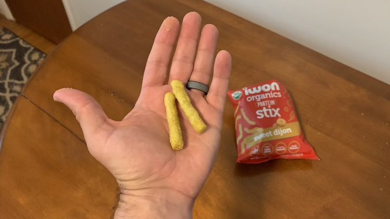 Two IWON Organics Protein Stix in our tester's hand.