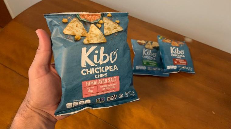 Our tester holding a bag of Kibo Chickpea Chips.