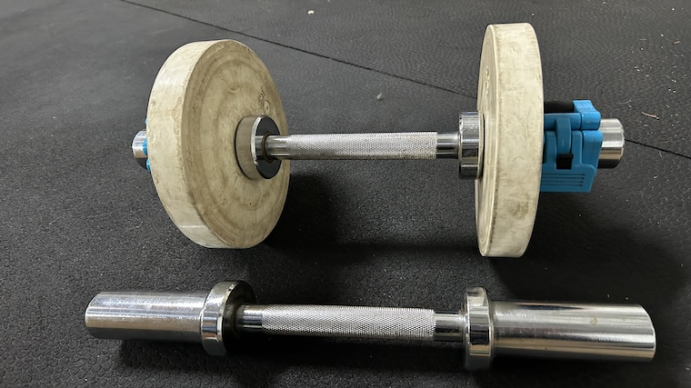 The Titan Fitness Loadable Dumbbells fixed with change plates and barbell collars