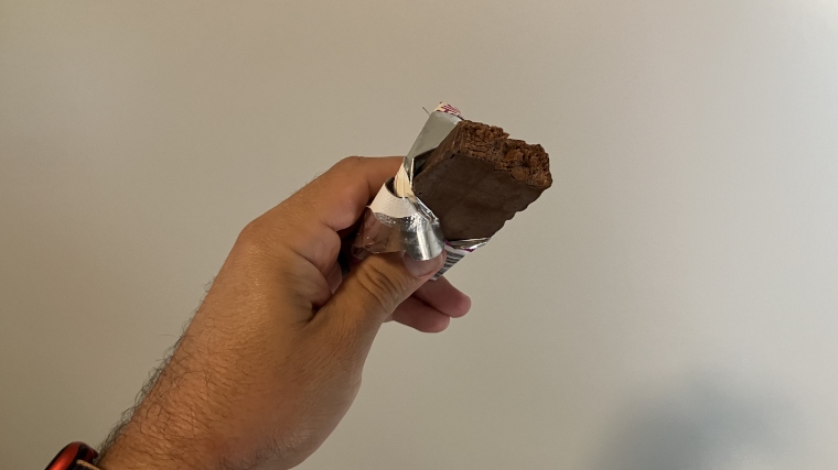 Looking down at a freshly-bitten Think! Nutrition Protein Bar held in hand