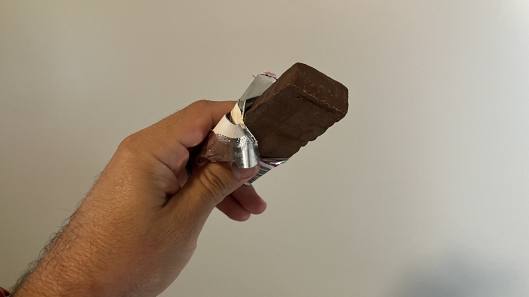 Looking down at a Think! Nutrition Protein Bar held in hand