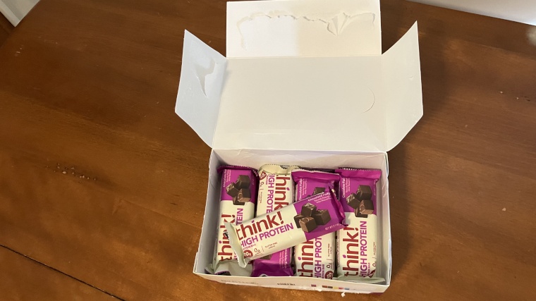 Looking down into a freshly opened box of Think! Nutrition Protein Bars