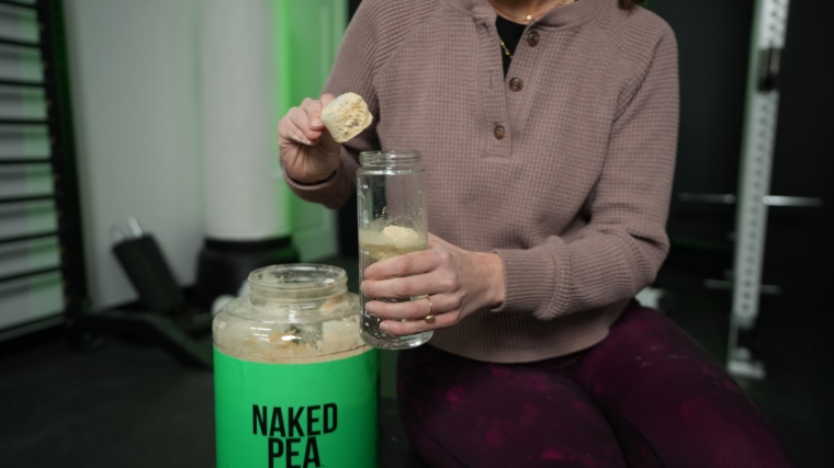 Our tester dumps a scoop of Naked Pea protein powder