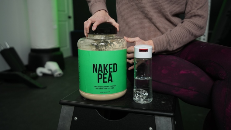 Our tester opening a massive container of Naked Pea protein powder