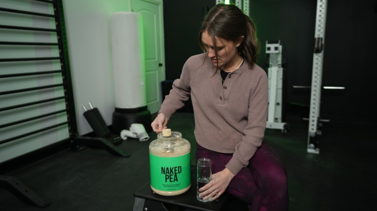 Our tester scooping some Naked Pea protein powder