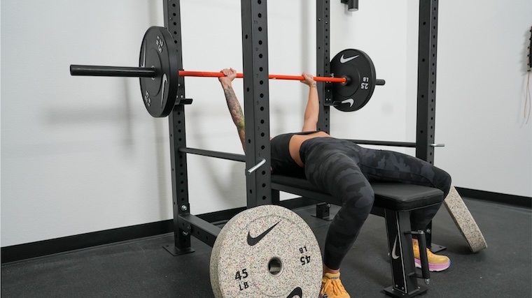 Our tester bench pressing with Nike Grind Bumper Plates