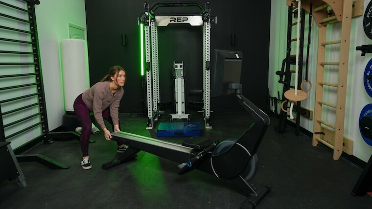 Our tester moving a NordicTrack rowing machine into position for a workout