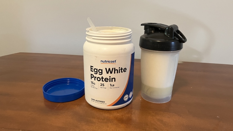 Nutricost Egg White Protein Powder on a table with a full cup