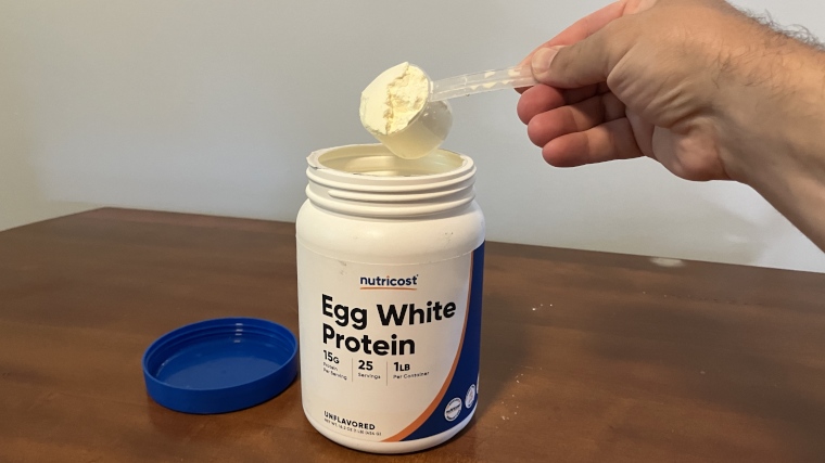 Our tester scooping Nutricost Egg White Protein Powder