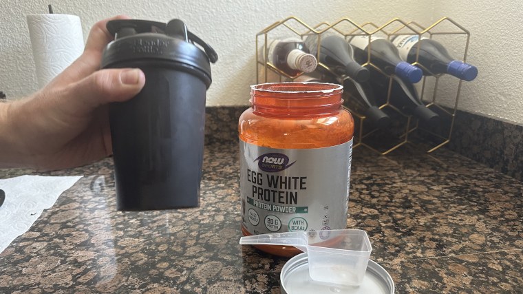 Our tester mixing a Now Sports Egg White Protein shake