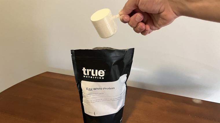 Our tester scooping True Nutrition Egg White Protein powder