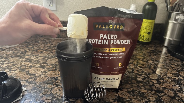 Our tester dumping a scoop of Paleo Pro protein powder