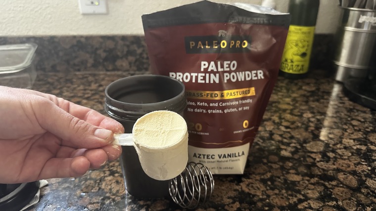 Our tester holding a scoop of Paleo Pro protein powder