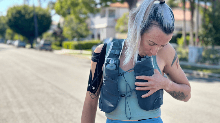 Our tester takes a sip from the Patagonia Slope Runner Vest's soft flasks.