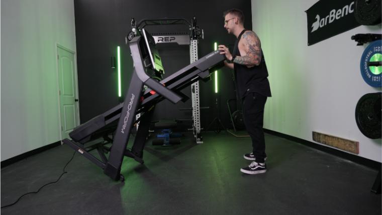 A man lowers the deck of the ProForm Carbon TLX treadmill.