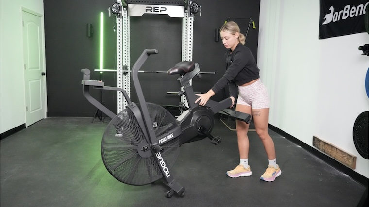 Our tester moving the Rogue Echo Air Bike into position for a workout