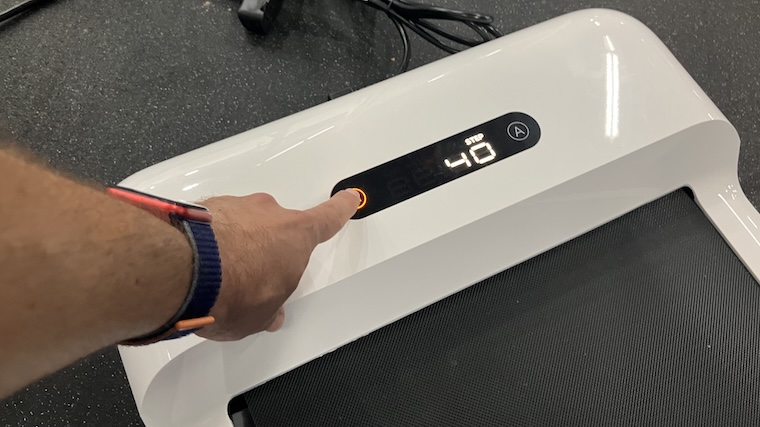 a person adjusting the WalkingPad C2 Mini Foldable Walking Treadmill.