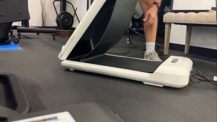 a person unfolding the WalkingPad C2 Mini Foldable Walking Treadmill.