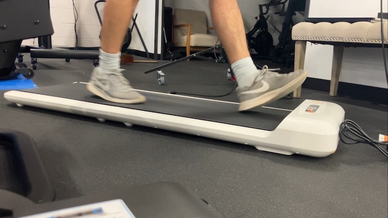 a person walking on the WalkingPad C2 Mini Foldable Walking Treadmill.