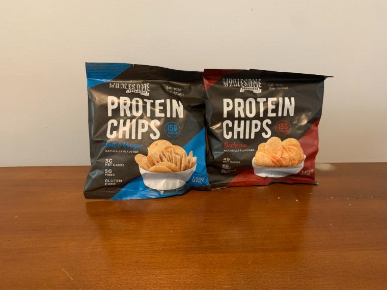 Two bags of Wholesome Provisions Protein Chips sitting on our tester's kitchen table.