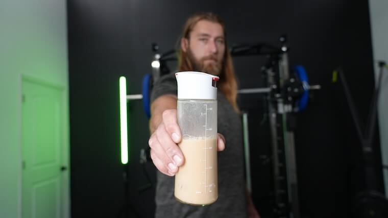 Our tester holding a mixed shaker of Legion Plant+ Protein