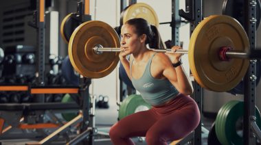 A woman back squatting