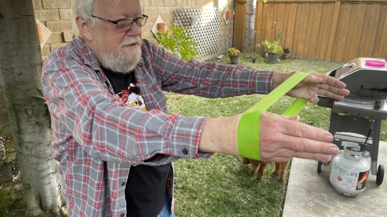 A man is shown doing strength exercises with an Iron Bull Mini Band