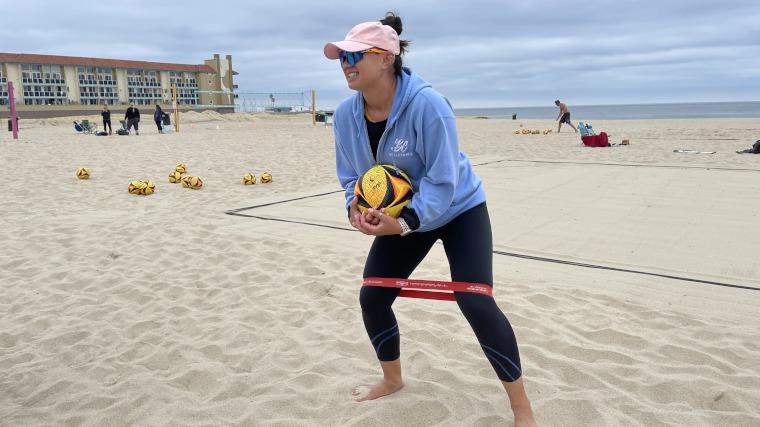 A volleyball player warms up with an Iron Bull Mini Band