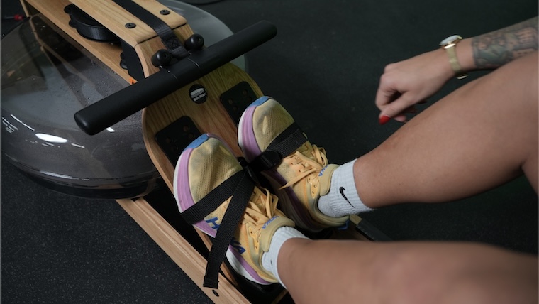 a person strapping their feet on the Ergatta Lite