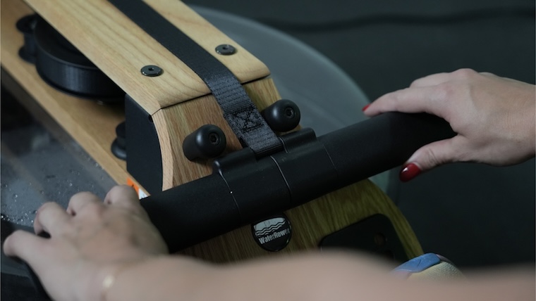 a person gripping the handlebar on the Ergatta Lite