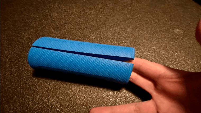 A hand shows off the slit side of Fat Gripz