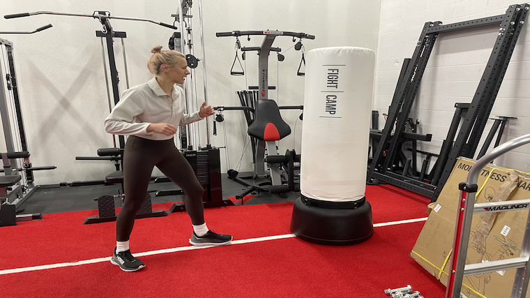 Our tester squaring up for a punch across FightCamp's free-standing punching bag