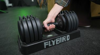 a person gripping the FLYBIRD Adjustable Dumbbells