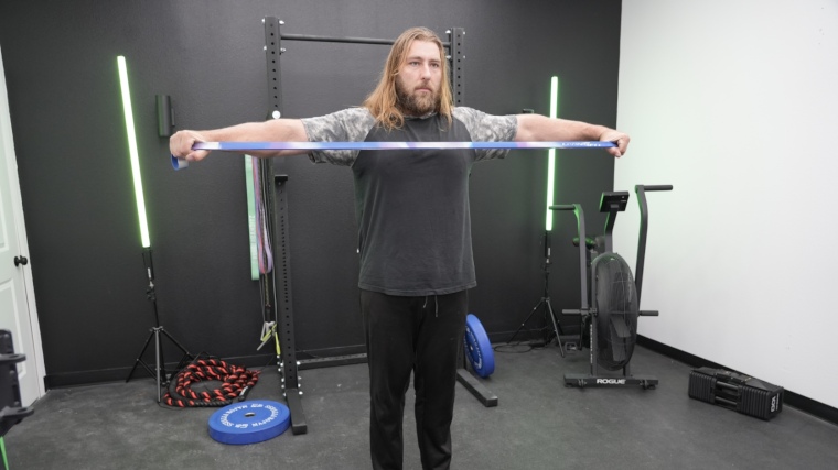 Full view of our tester stretching out the blue Living Fit Resistance Band