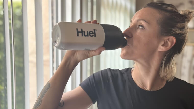 a person drinking Huel Black edition