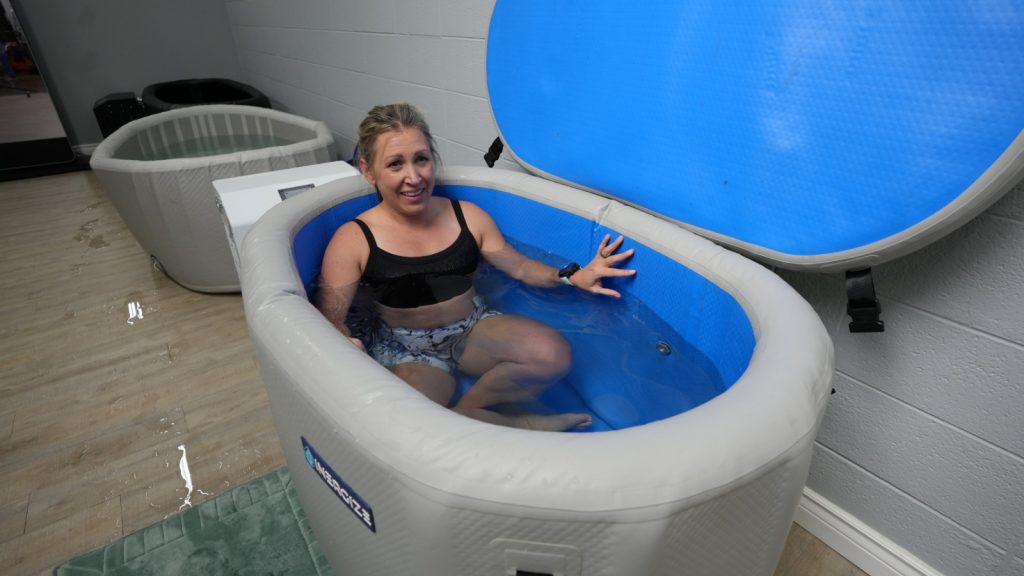 Our tester doing a plunge in the Inergize Cold Hot Tub.