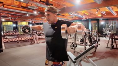 Jay Cutler performs dumbbell lateral raises.