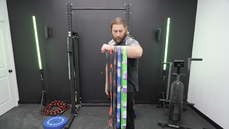 Full view of our tester draping all of the Living Fit Resistance Bands over his arm