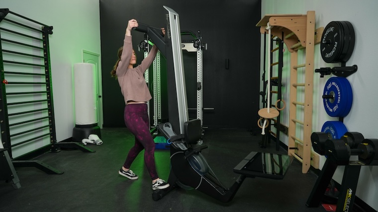 Our tester getting their NordicTrack rowing machine out of its vertical storage positioning