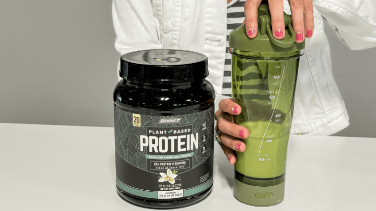 Tester mixes Onnit Plant-Based Protein powder in a bottle.