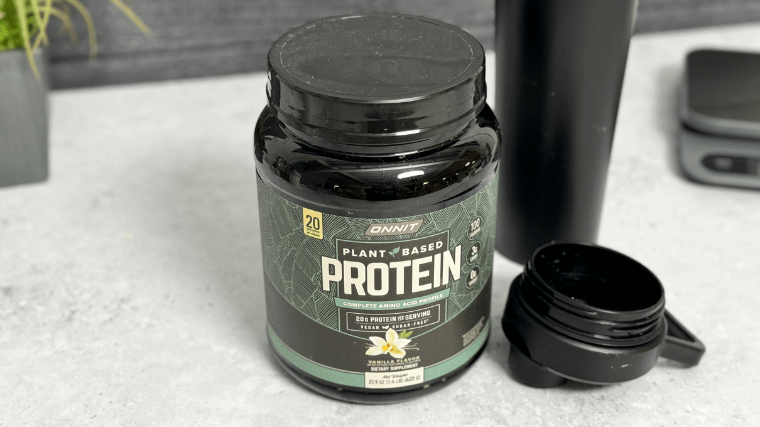 Onnit Plant-Based Protein besides an empty bottle.