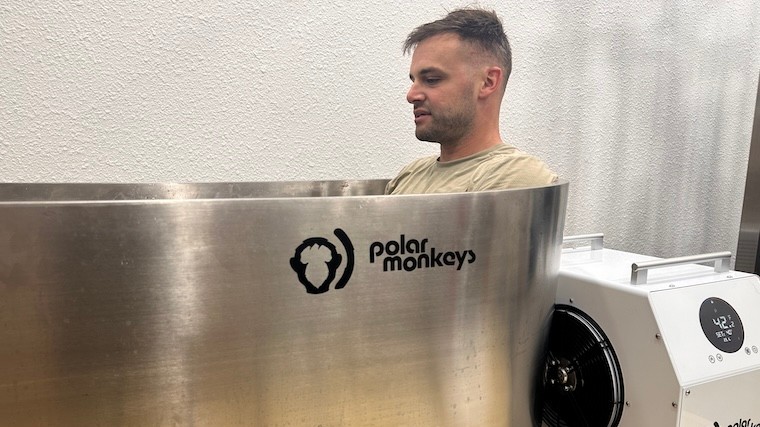 a person sitting in a cold plunge tub